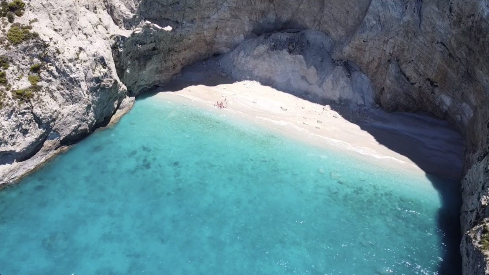 An empty cove under the west-coast cliffs of Zakynthos, white pebbles and turquoise water