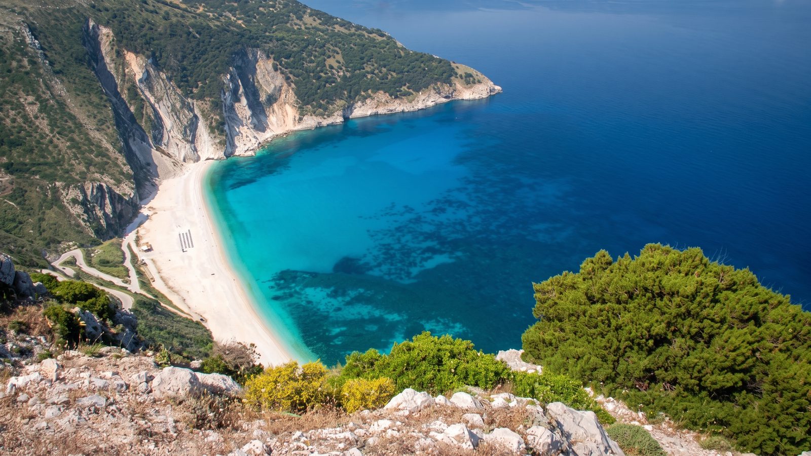 Myrtos beach from the cliff road: the white crescent and the turquoise bay