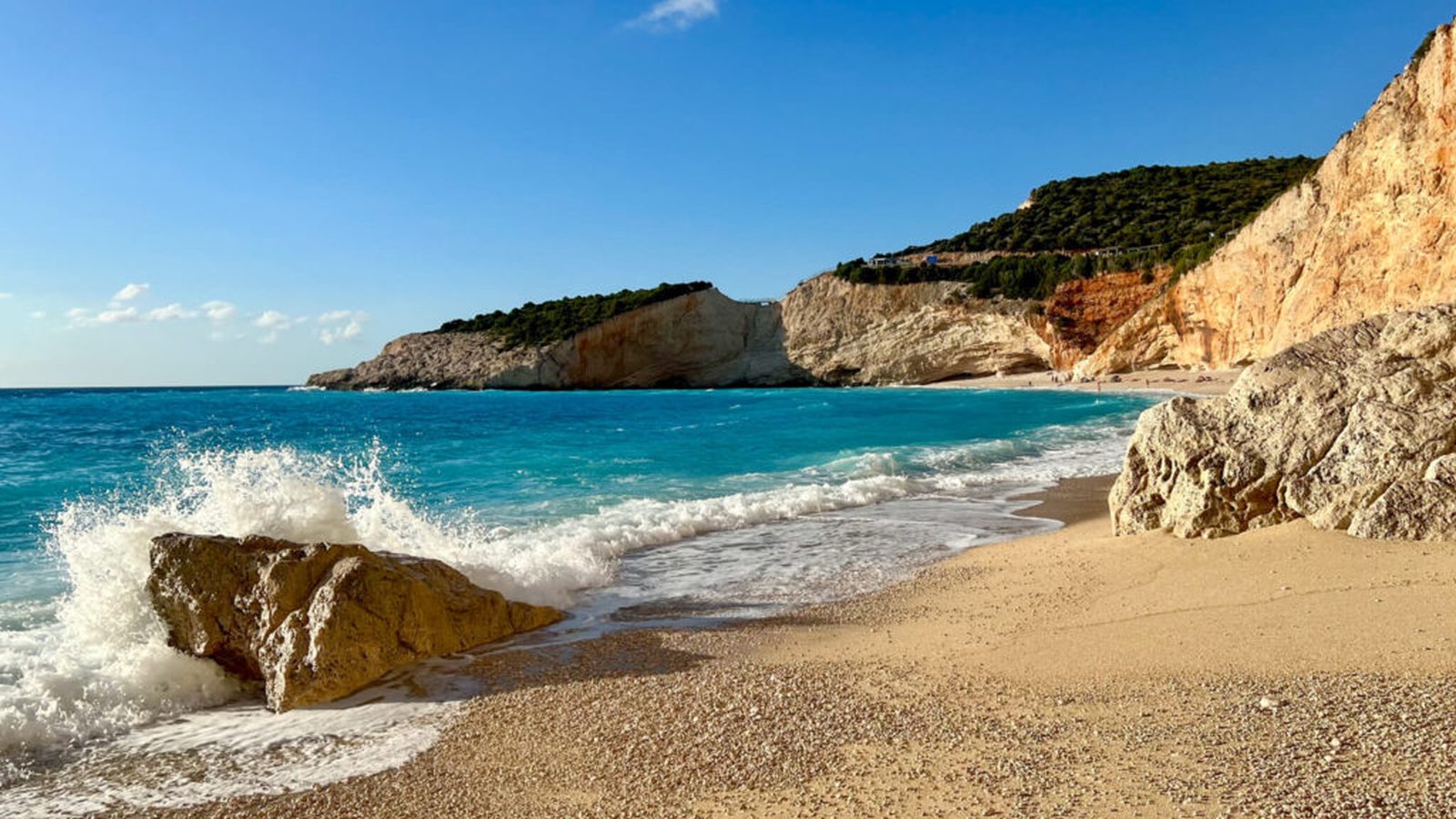 Porto Katsiki: surf on the pebbles and the white cliff falling into turquoise water