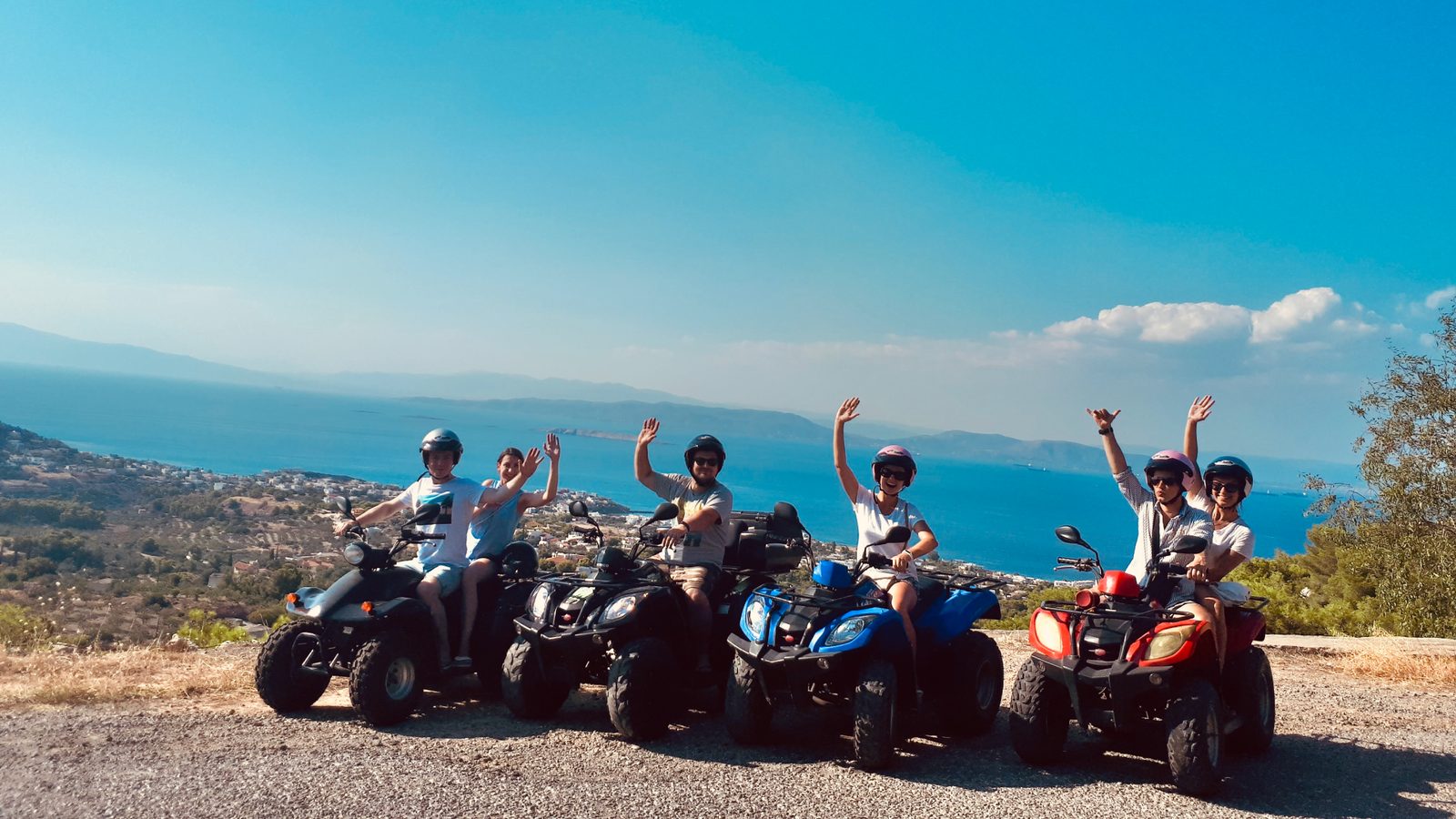 The group on quad bikes on a hill road above the sea, Poros