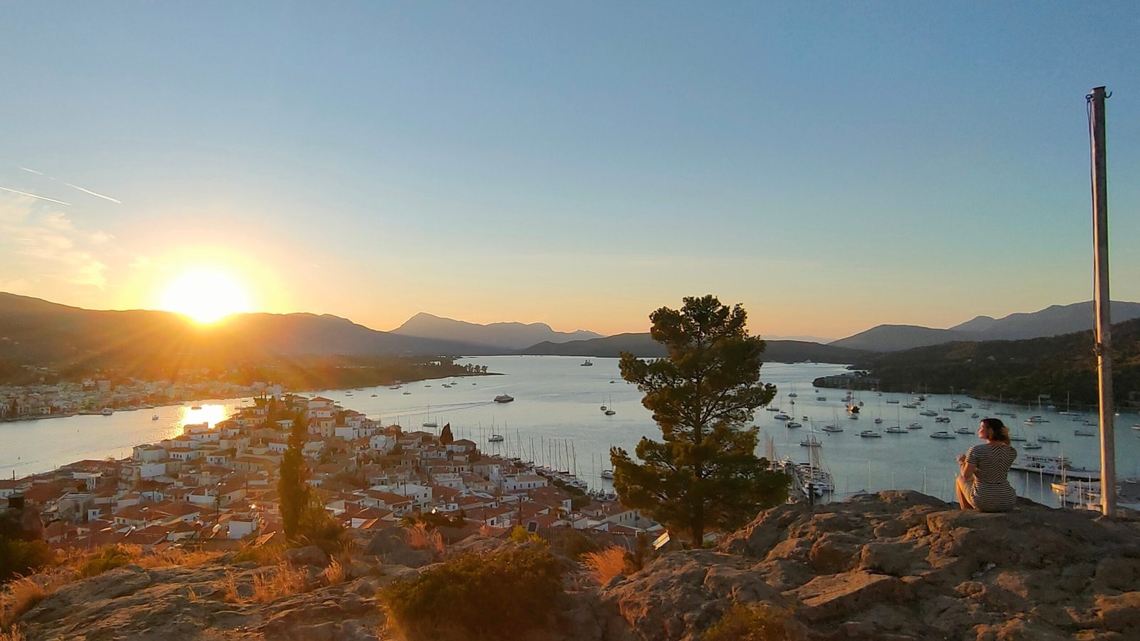 Sunrise from the chapel hill above Poros: the channel, the town and the boats below
