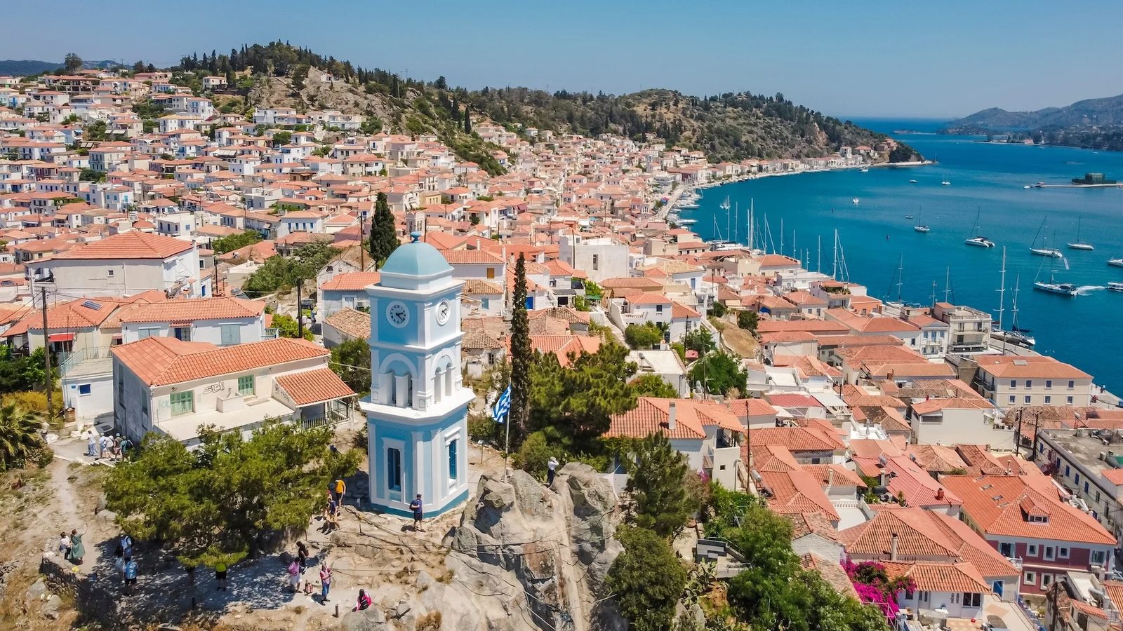 The clock tower of Poros from the air as the boat leaves for Hydra