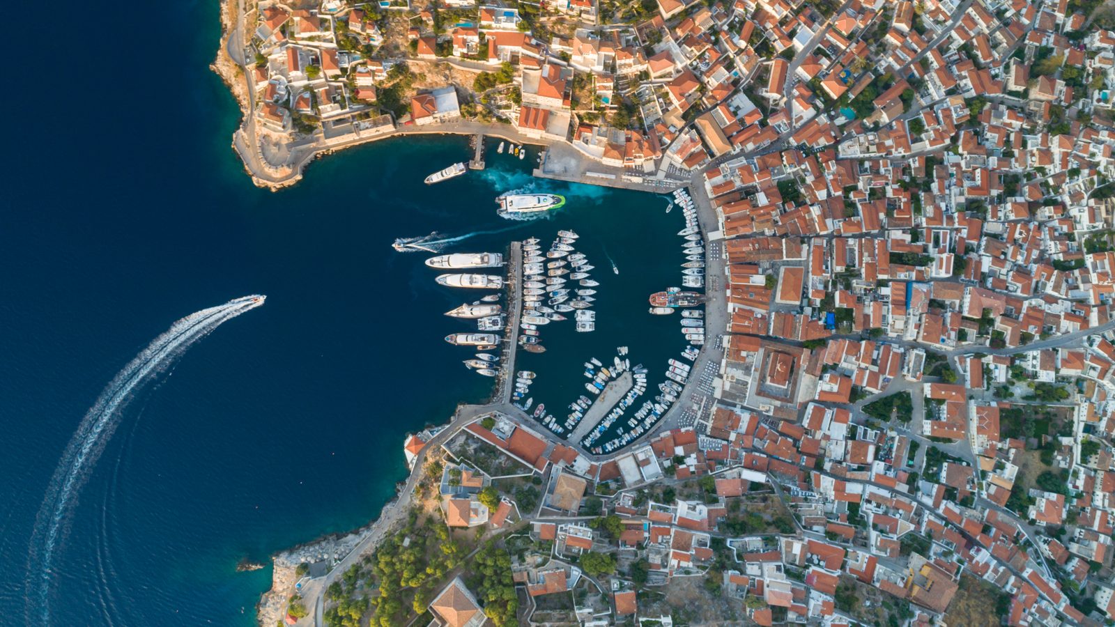 Hydra harbour from the air: the stone shipowners&rsquo; houses climbing the slope