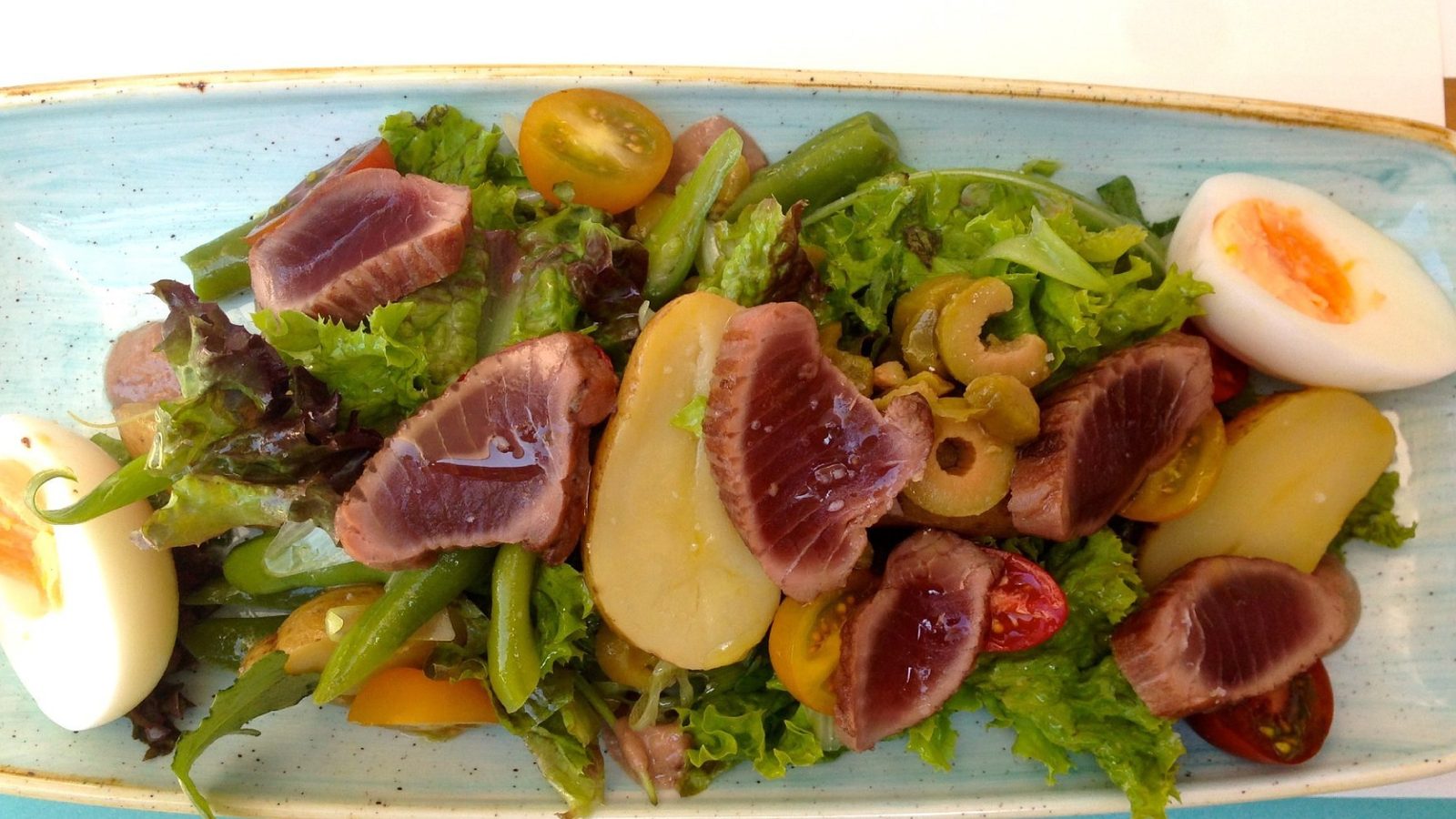 Tuna salad nicoise for lunch on Hydra: seared tuna, potatoes, olives and egg