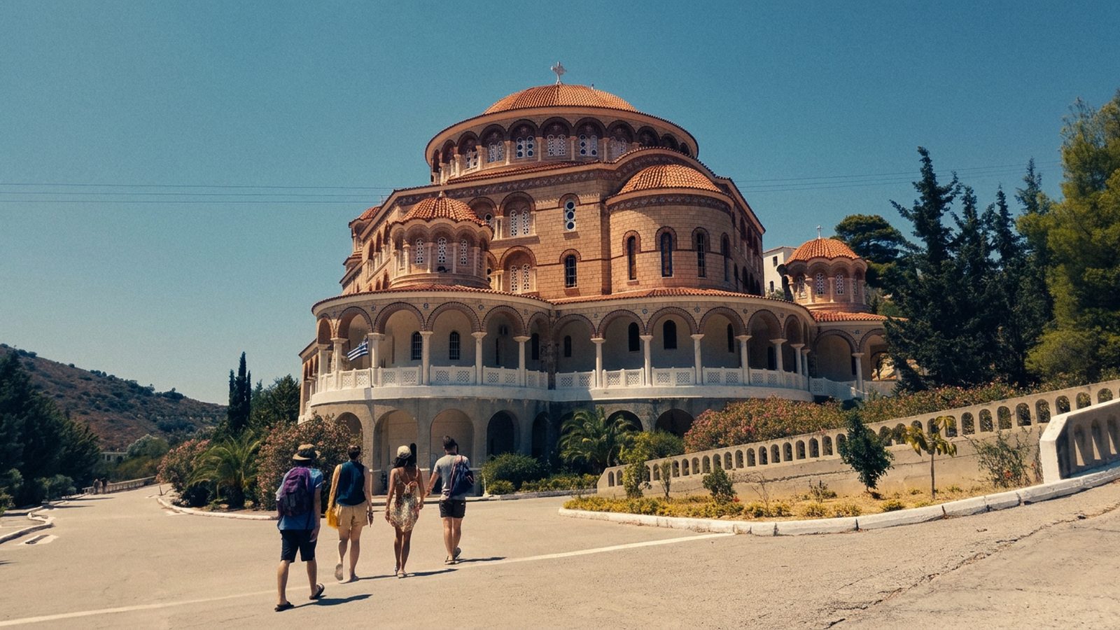 The group walking up to the Monastery of Agios Nektarios, its red domes against the sky