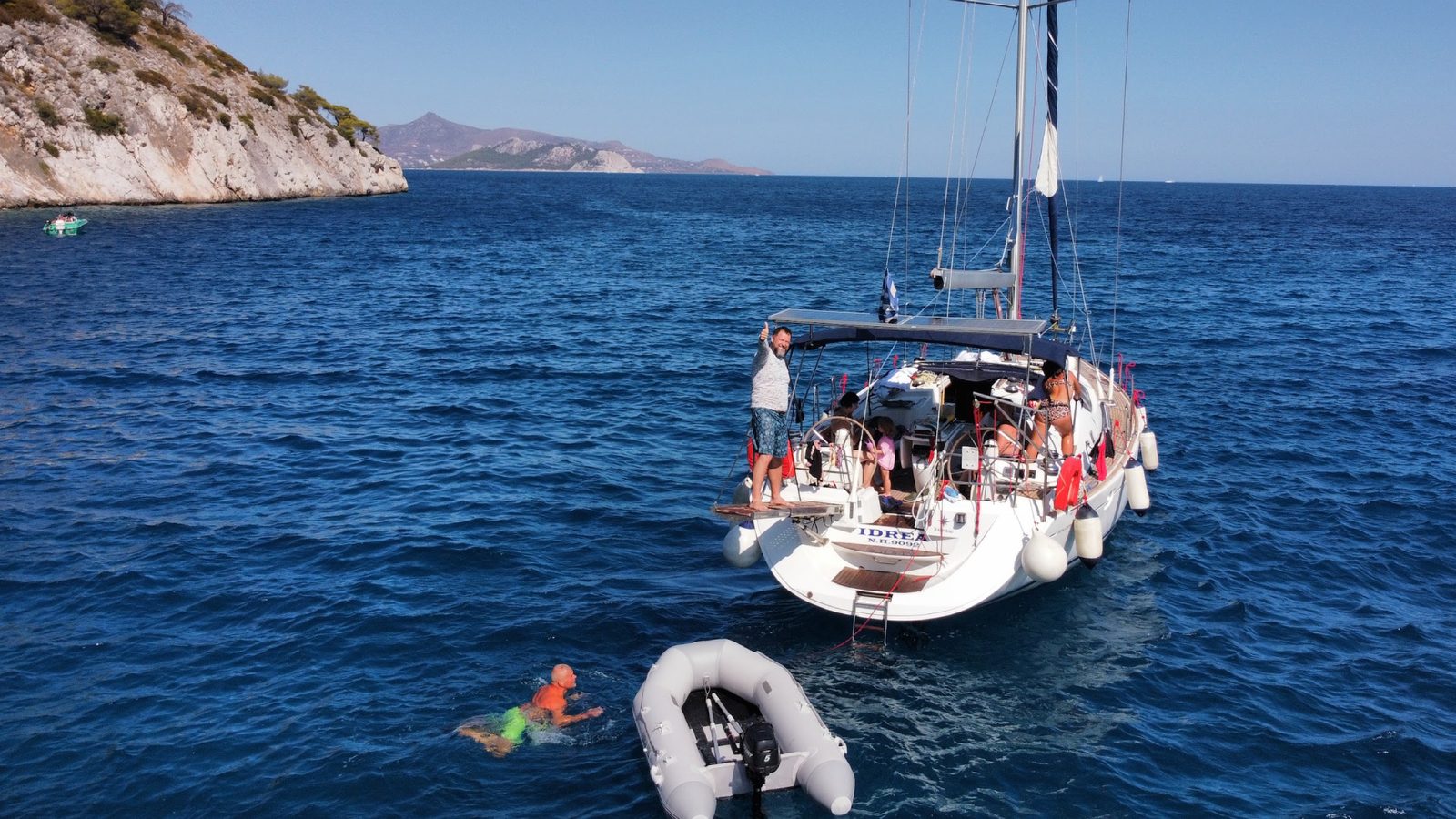 The last swim stop of the week, crew on deck and in the water off a quiet cove